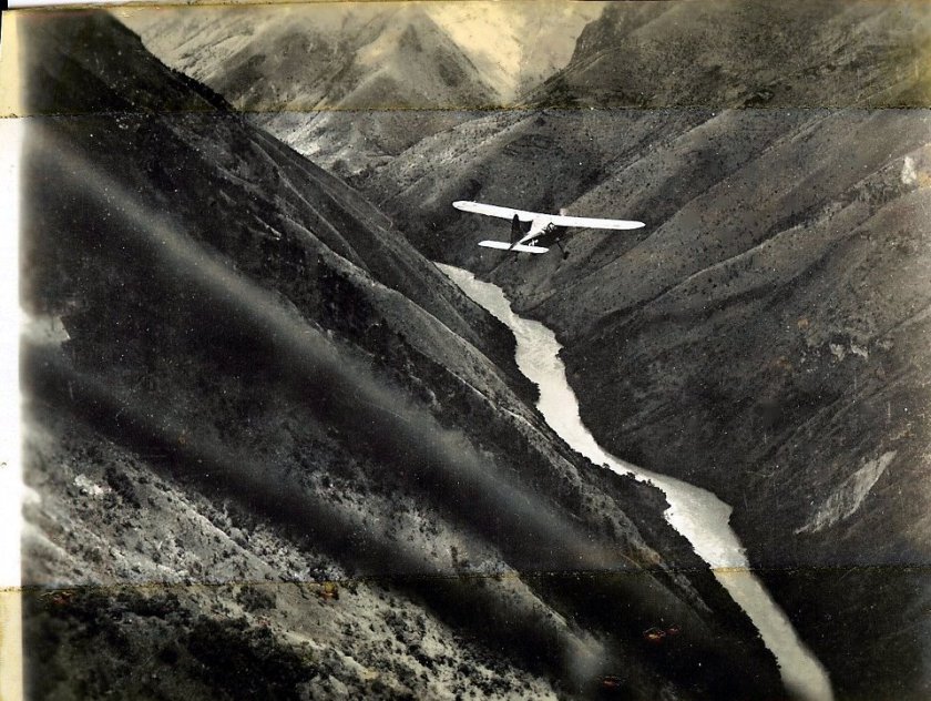graphic of monoplane flying a mountain pass